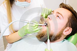 Caucasian male sitting in the dentist office.