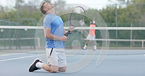 Caucasian male tennis player reacts to losing against happy diverse opponent on court in slow motion