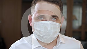 Caucasian man adult wearing anti-virus bacteria disease pollution protective mask looking to camera.