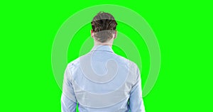 Caucasian man back to camera on green background