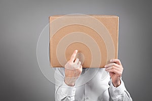 Caucasian man with a cardboard box over his head