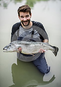 Caucasian Man caught salmon fish