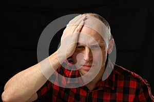 A Caucasian man clutched his head