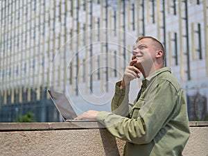 Caucasian man communicates in sign language via video link on laptop.