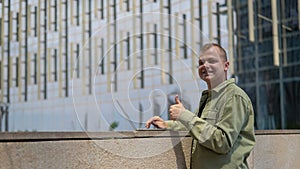 Caucasian man communicates in sign language via video link on laptop. Guy showing thumbs up.