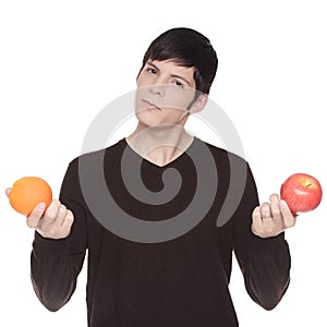 Caucasian man comparing apple to orange photo