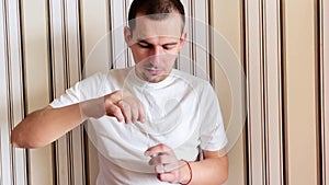 Caucasian man doing an antigentest for coronavirus. The collected smear from the nasopharynx is dipped into the reagent