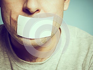 Caucasian man with duct tape on mouth, white .