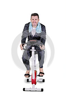 Caucasian man exercise on a spin bike in the studio