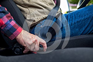 Caucasian man fastening seat belt in car