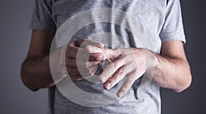 Caucasian man with finger ache. Arthritis, wrist pain