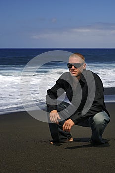 Caucasian man with glasses on the beach