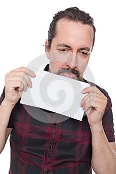Caucasian man holding and licking a white envelope
