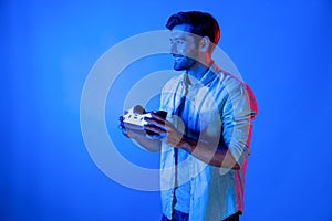 Caucasian man holding VR headset and using to connect metaverse. Deviation.