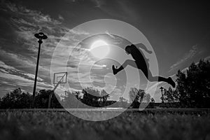 Caucasian man jumping with high hip raise outdoors.