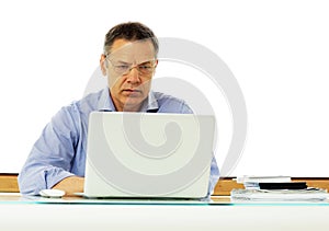 Caucasian man looking at his laptop computer