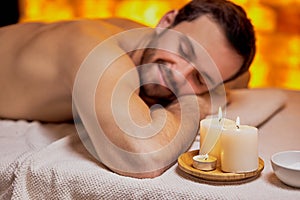 Caucasian man lying on massage table and relx