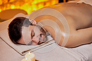 Caucasian man lying on massage table and relx