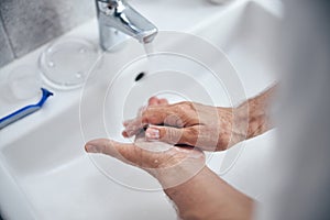 Caucasian man maintaining the proper hand hygiene