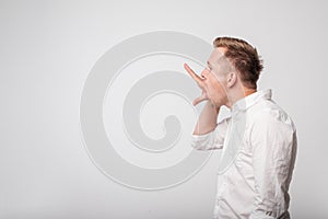 Caucasian man making bla bla sign with his hand. Empty promises.