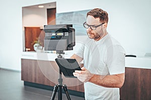 Caucasian man with Matterport camera and Tablet doing 3d Scan Virtual Tour indoors photo