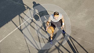 Caucasian man playing basketball alone, dribbling ball, practicing free throws