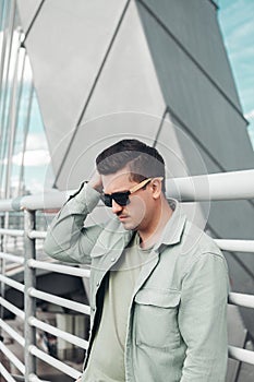 Caucasian man portrait white young stylish hairstyle in sunglasses.