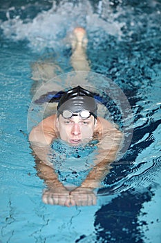 Caucasian man practicing flutter kick with kick board photo