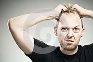 Caucasian Man Pulling Out Hair WIth Frustration