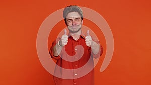 Caucasian man raises thumbs up agrees gives positive reply recommends advertisement likes good idea