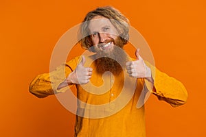 Caucasian man raises thumbs up agrees gives positive reply recommends advertisement likes good idea