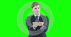 Caucasian man raising hands on green background