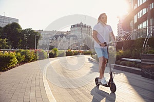 Caucasian man riding electric scooter against cityscape