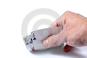 Caucasian man`s hand showing flowers poker cards, ace and king, isolated on white background