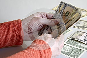 Caucasian man`s hands counting dollar banknotes