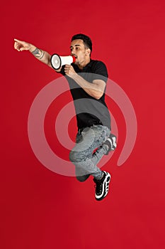 Caucasian man& x27;s portrait isolated over color studio background with copyspace. High jump
