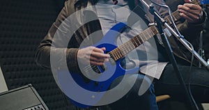 Caucasian man singing song and playing guitar