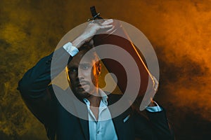 Caucasian man in suit holding fire extinguisher