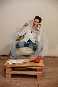 A caucasian man is talking on the phone