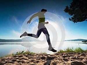 Caucasian man training on the beach in morning