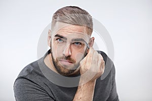 Caucasian Man Tweezing Eyebrows
