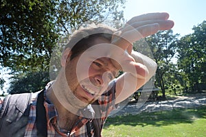 Caucasian man under hot bright sun. photo