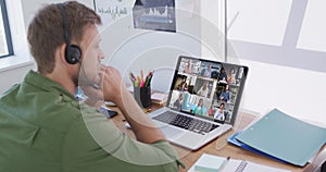 Caucasian man using laptop and phone headset on video call with colleagues