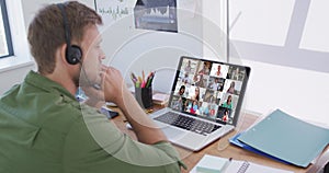 Caucasian man using laptop and phone headset on video call with colleagues