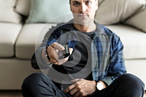 Caucasian man using remote tv controller