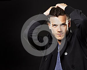 Caucasian man wearing black tshirt and trendy hairstyle