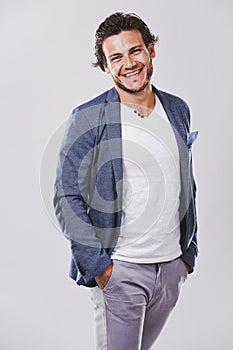 caucasian man wearing blue jacket white shirt and trendy hairstyle