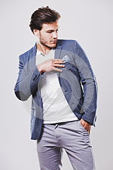 caucasian man wearing blue jacket white shirt and trendy hairstyle