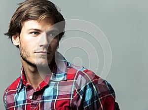 Caucasian man wearing checkered shirt and trendy hairstyle