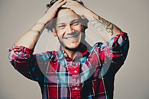 Caucasian man wearing checkered shirt and trendy hairstyle